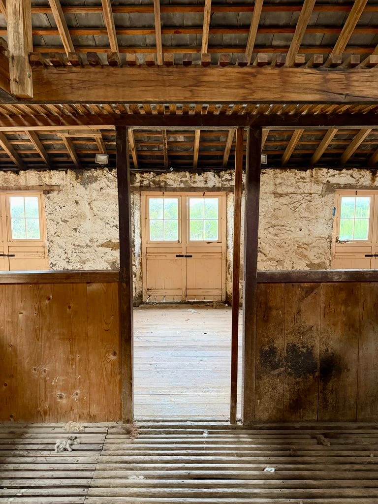 Interior of the 1,400 sq. ft. converted barn studio in Bishop, California, with a large oil landscape on the easel under north light.